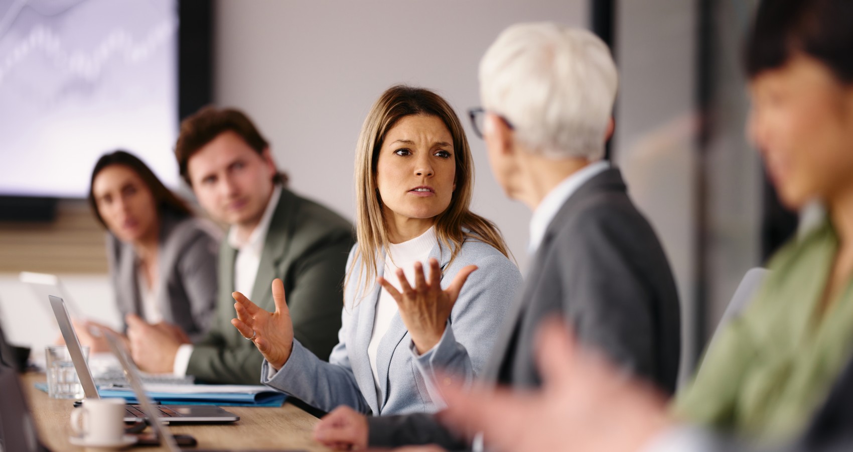 Businesswoman arguing with colleague in office meeting