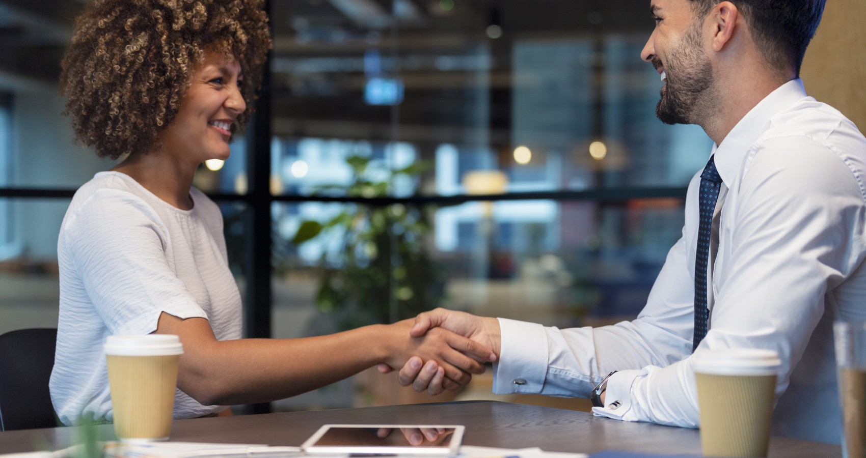 Business man woman shaking hands in office