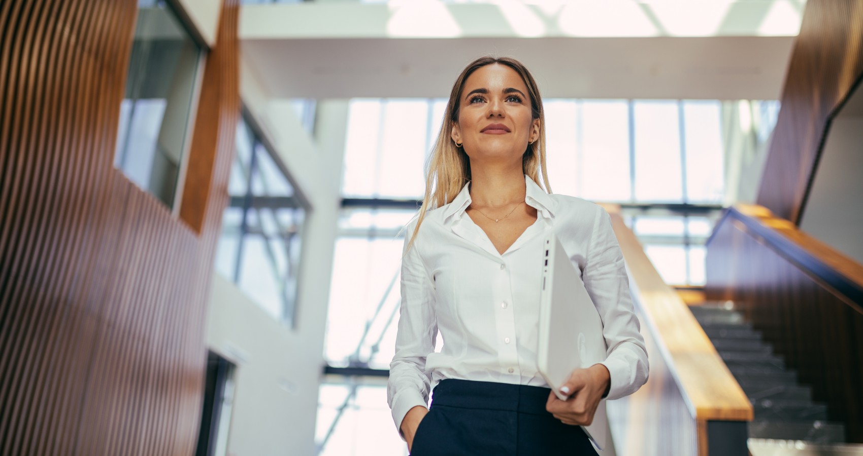 Confident businesswoman walking through office building
